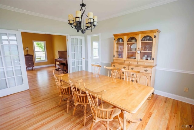 490 Hidden Falls Rd, Tully, NY 13159 - dining area featuring light wood finished floors, a chandelier, baseboards, and crown molding