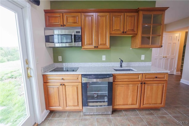 490 Hidden Falls Rd, Tully, NY 13159 - kitchen with stainless steel microwave, wine cooler, a sink, black electric stovetop, and glass insert cabinets