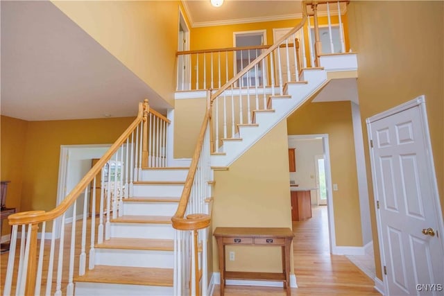 490 Hidden Falls Rd, Tully, NY 13159 - stairway featuring wood finished floors, a towering ceiling, baseboards, and crown molding
