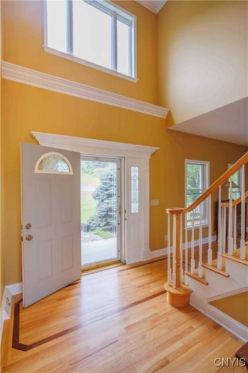 490 Hidden Falls Rd, Tully, NY 13159 - entryway with wood finished floors, stairway, a high ceiling, and baseboards