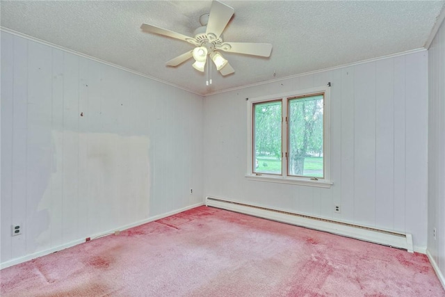 empty room featuring a baseboard heating unit, a textured ceiling, ornamental molding, carpet, and ceiling fan