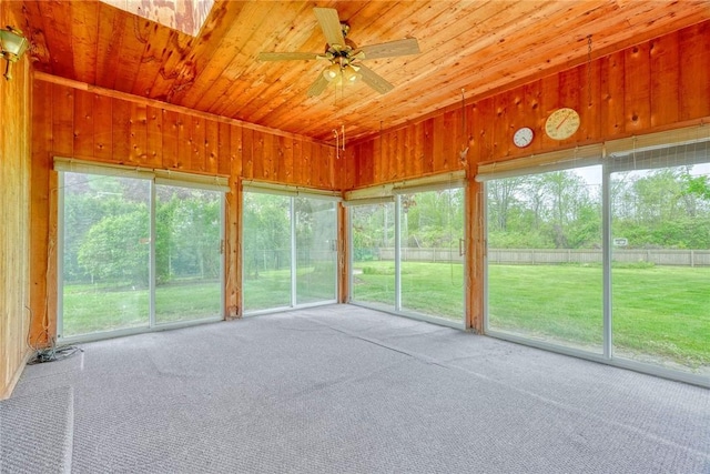 unfurnished sunroom featuring ceiling fan and healthy amount of natural light