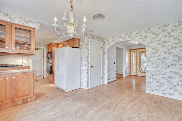 kitchen with black appliances, wallpapered walls, arched walkways, a chandelier, and light wood-style floors