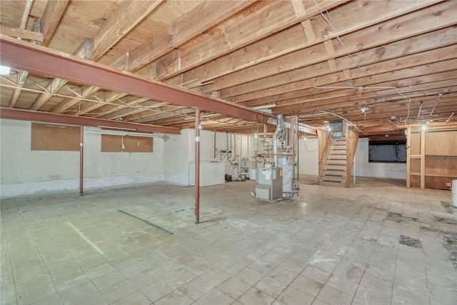 unfinished basement featuring stairs, a heating unit, and tile patterned floors