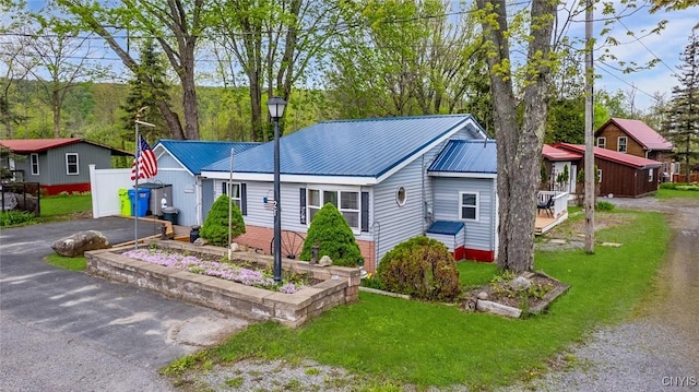 21 S Lake Rd, Deruyter, NY 13052 - view of front of property with driveway, a front lawn, and metal roof
