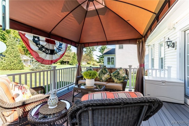 wooden deck featuring a gazebo and an outdoor living space