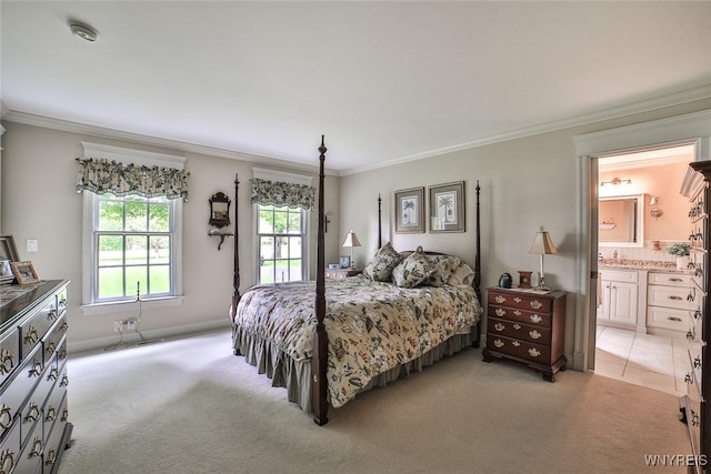 bedroom with light carpet, crown molding, and connected bathroom