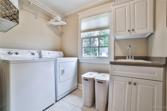 laundry area with washer and dryer, cabinet space, light tile patterned floors, and crown molding