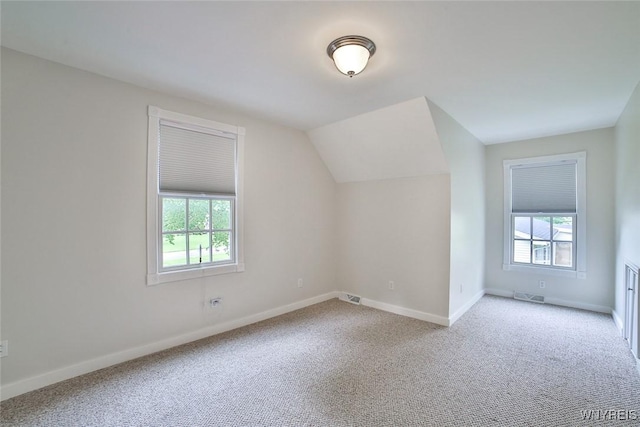 bonus room with carpet floors, plenty of natural light, baseboards, and vaulted ceiling