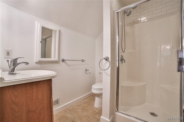 full bath with a stall shower, toilet, vanity, and baseboards