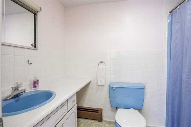 89 Chapel St, Mount Morris, NY 14510 - bathroom with tile walls, vanity, toilet, a shower with shower curtain, and a baseboard heating unit