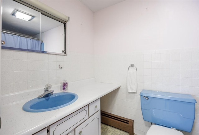 89 Chapel St, Mount Morris, NY 14510 - full bath with a baseboard heating unit, tile walls, vanity, and toilet
