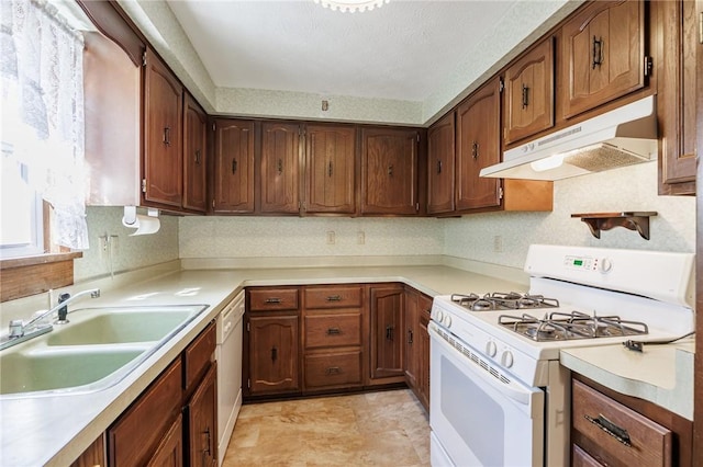 89 Chapel St, Mount Morris, NY 14510 - kitchen with white appliances, under cabinet range hood, a sink, and light countertops