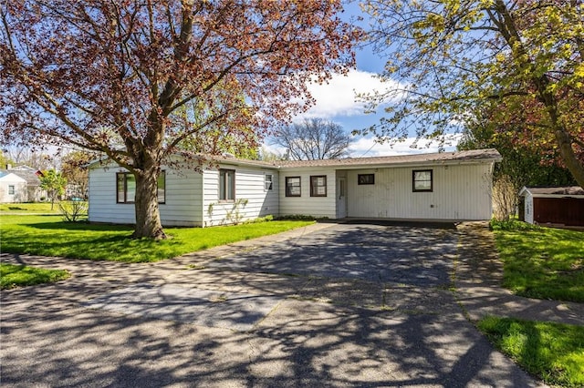 89 Chapel St, Mount Morris, NY 14510 - single story home featuring driveway, a carport, and a front lawn