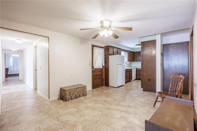 89 Chapel St, Mount Morris, NY 14510 - kitchen with white appliances, ceiling fan, dark brown cabinets, light floors, and light countertops