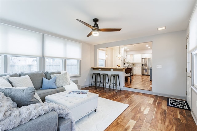 164 Elm Dr, Rochester, NY 14609 - living area featuring a ceiling fan, wood finished floors, and baseboards