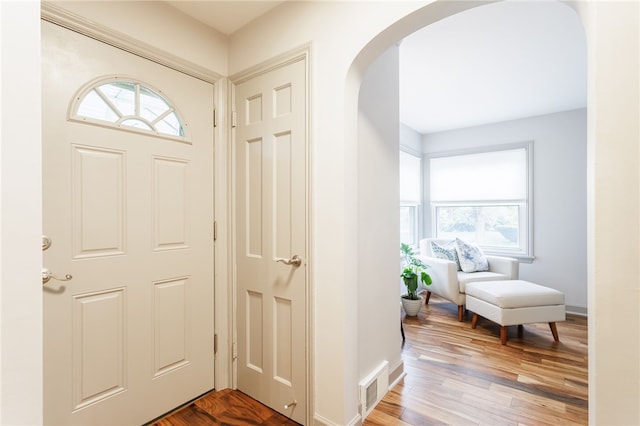 164 Elm Dr, Rochester, NY 14609 - entrance foyer featuring arched walkways, plenty of natural light, baseboards, and light wood-style floors