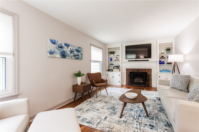 164 Elm Dr, Rochester, NY 14609 - living area with wood finished floors, a fireplace, built in features, and baseboards