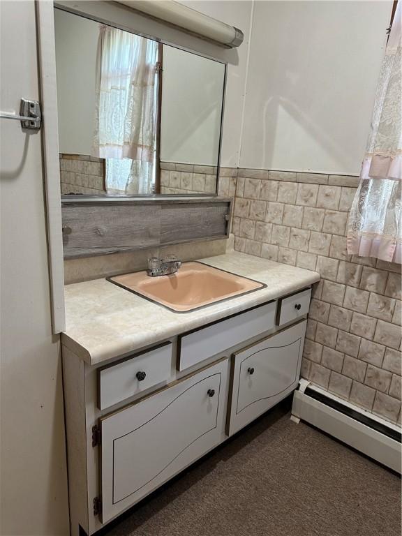 22 Suncrest Ter, Oneonta-City, NY 13820 - bathroom with a baseboard radiator, vanity, and tile walls