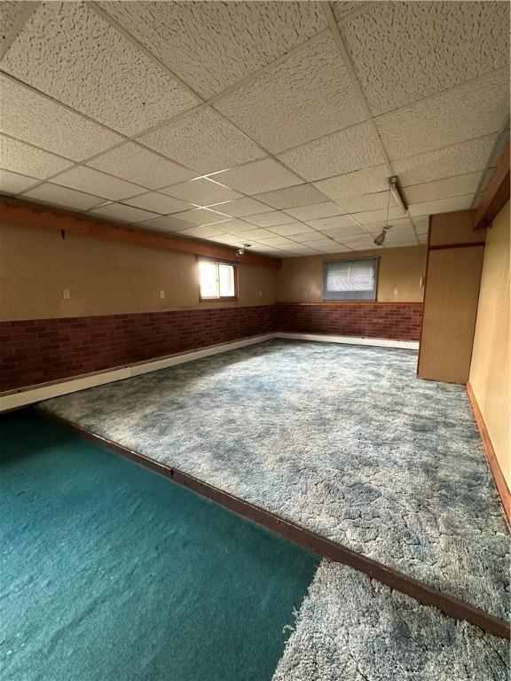 22 Suncrest Ter, Oneonta-City, NY 13820 - below grade area with carpet, a drop ceiling, baseboards, and brick wall