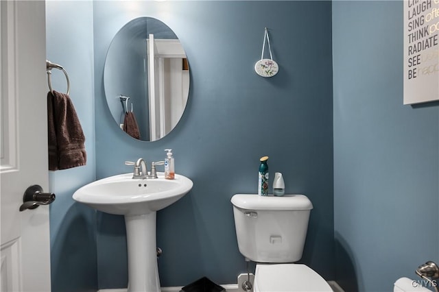half bath with toilet and a sink