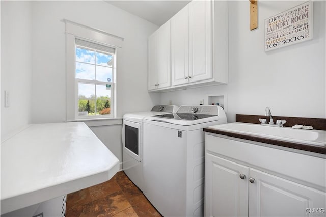 clothes washing area featuring cabinet space, separate washer and dryer, and dark stone finish flooring