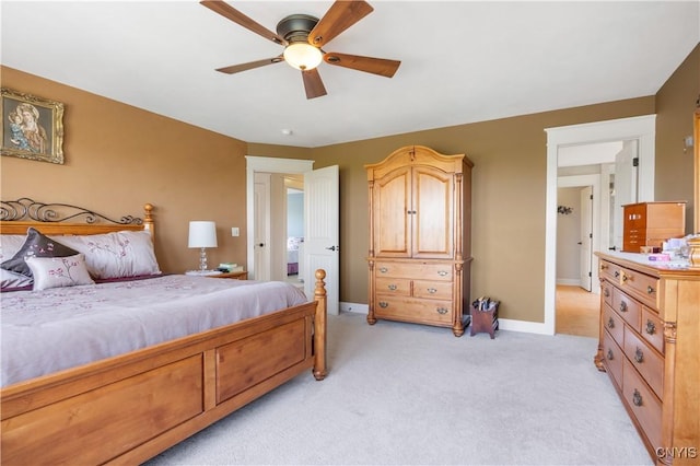 bedroom with light carpet, baseboards, and ceiling fan