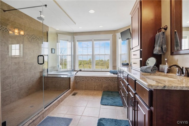 bathroom with tile patterned flooring, a stall shower, a bath, vanity, and recessed lighting