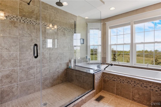 bathroom with healthy amount of natural light, a stall shower, and recessed lighting