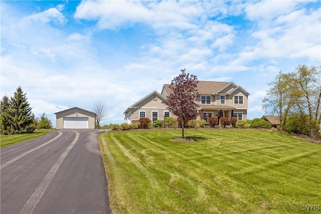 view of front of home with an outbuilding, a garage, and a front yard