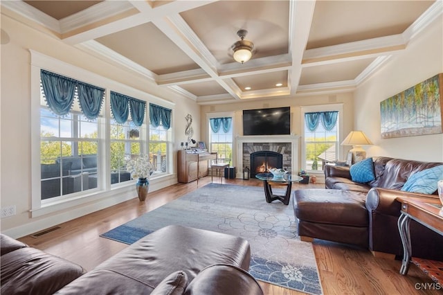 living area featuring a fireplace, beam ceiling, wood finished floors, and coffered ceiling