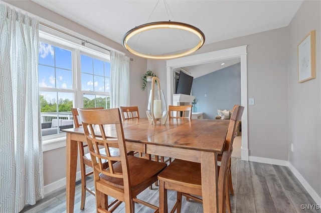 dining area featuring wood finished floors and baseboards