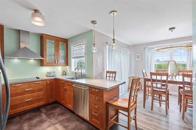 kitchen with wall chimney exhaust hood, dishwasher, a sink, brown cabinetry, and black electric stovetop