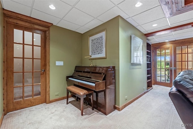 living area with baseboards, carpet flooring, recessed lighting, and a paneled ceiling