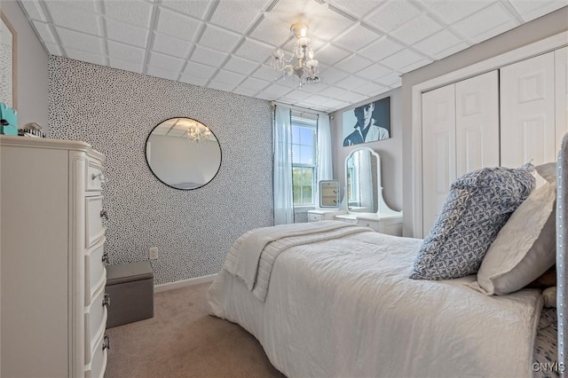 bedroom with carpet flooring, a closet, and baseboards