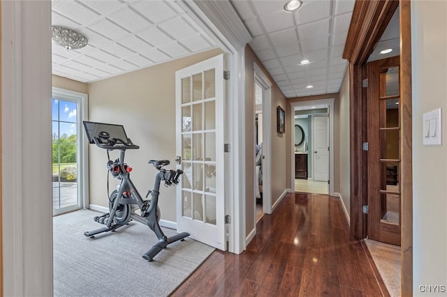 workout room featuring baseboards, wood finished floors, and recessed lighting