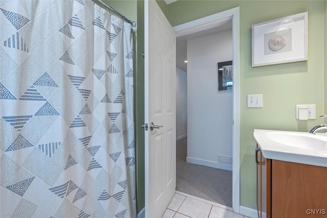 full bath with tile patterned flooring, vanity, baseboards, and a shower with shower curtain