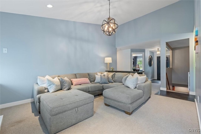 living area featuring baseboards, a chandelier, carpet floors, a high ceiling, and recessed lighting