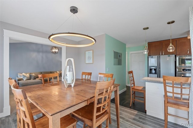 dining area with dark wood-style floors and baseboards