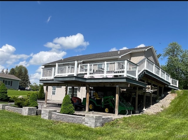 rear view of house with a wooden deck and a yard