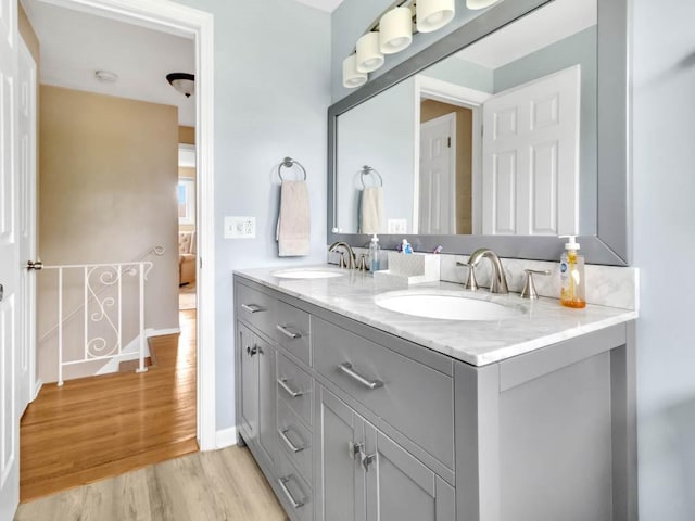 163 Lyncourt Park, Greece, NY 14612 - bathroom with wood finished floors, double vanity, and baseboards
