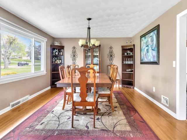 163 Lyncourt Park, Greece, NY 14612 - dining space featuring a chandelier, baseboards, and light wood-style floors