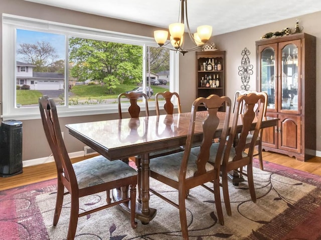 163 Lyncourt Park, Greece, NY 14612 - dining space featuring light wood-style floors, a chandelier, and baseboards