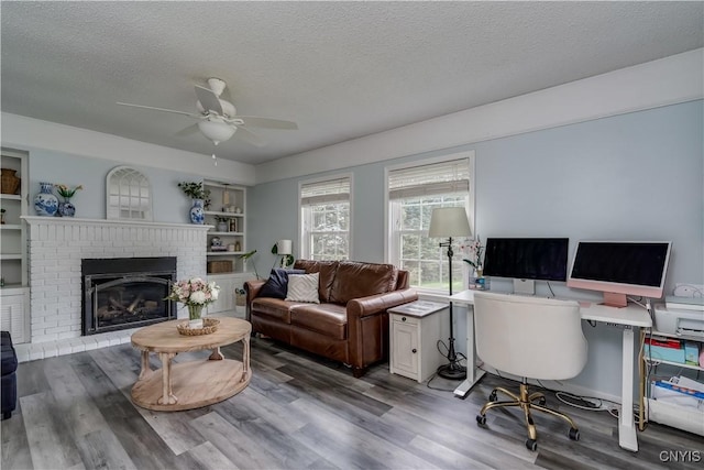 467 Barben Ave, Watertown-City, NY 13601 - office area featuring a textured ceiling, wood finished floors, a ceiling fan, and a fireplace