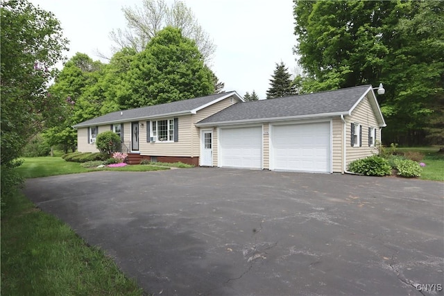 view of front of home with driveway and an attached garage