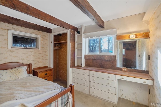419 Glenwood Ln, Niles, NY 13021 - carpeted bedroom with wallpapered walls, beamed ceiling, and a closet