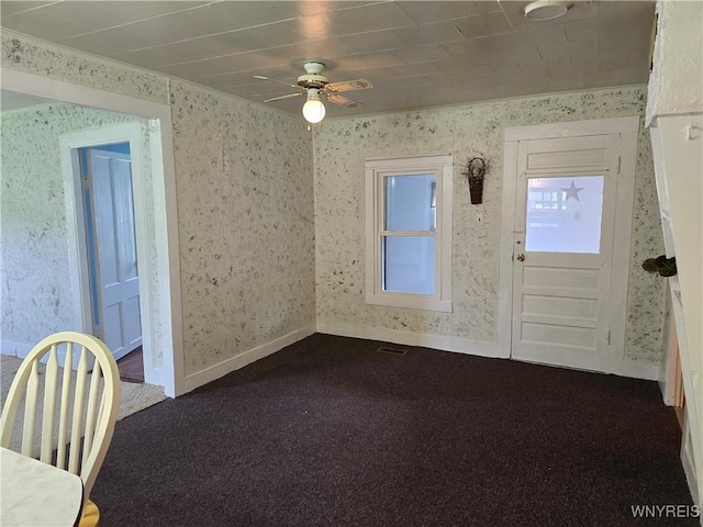 2282 Rte 305, Clarksville, NY 14727 - unfurnished dining area with wallpapered walls, a ceiling fan, dark carpet, and baseboards