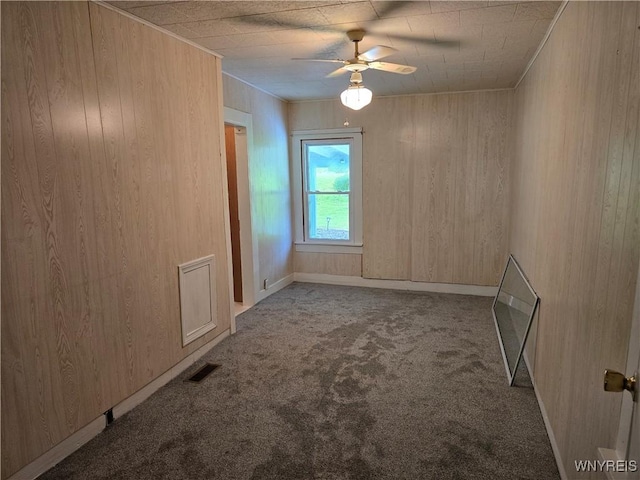 2282 Rte 305, Clarksville, NY 14727 - carpeted empty room with a ceiling fan, wood walls, and baseboards