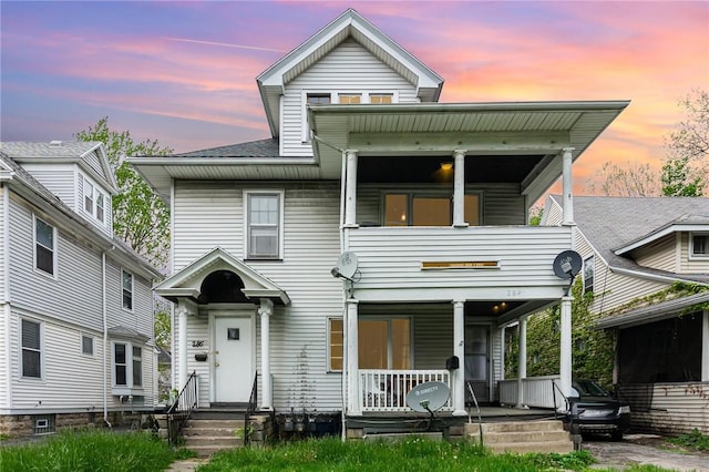 view of front of house featuring a porch and a balcony
