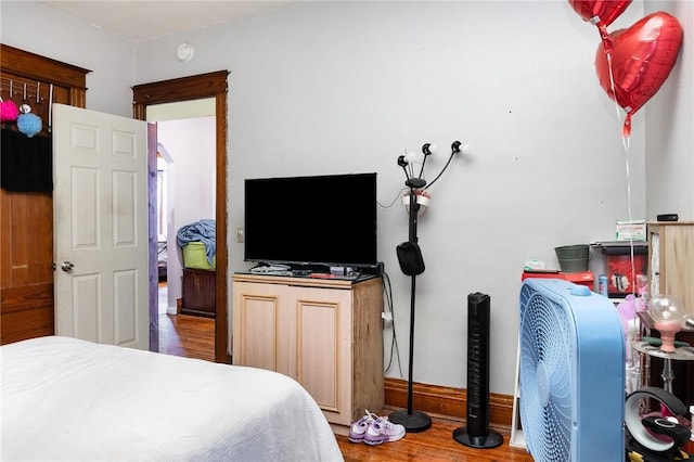 bedroom with wood finished floors and baseboards